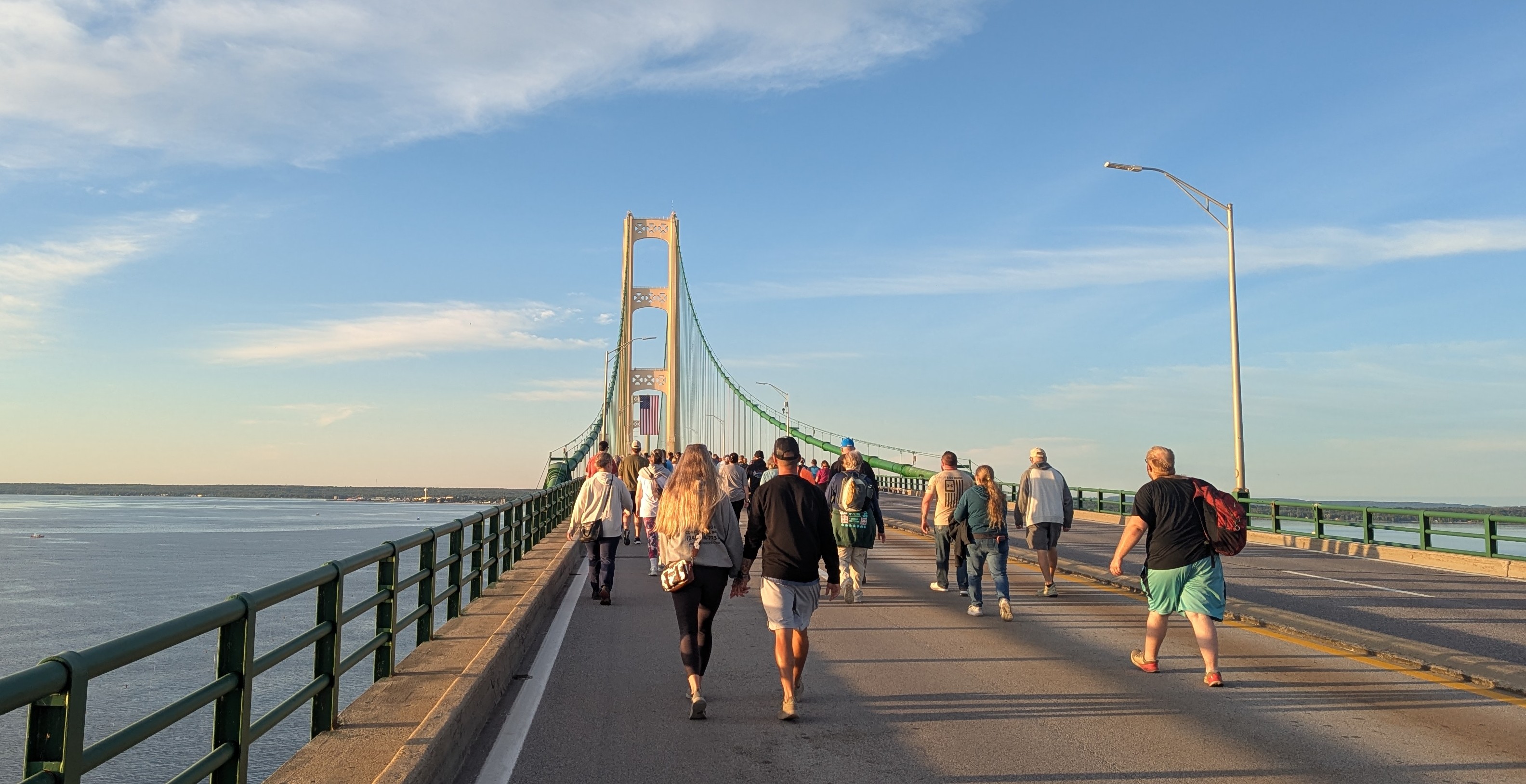 View looking south at the northern pillar of the Mackinac Bridge. An American flag is hung from the pillar.